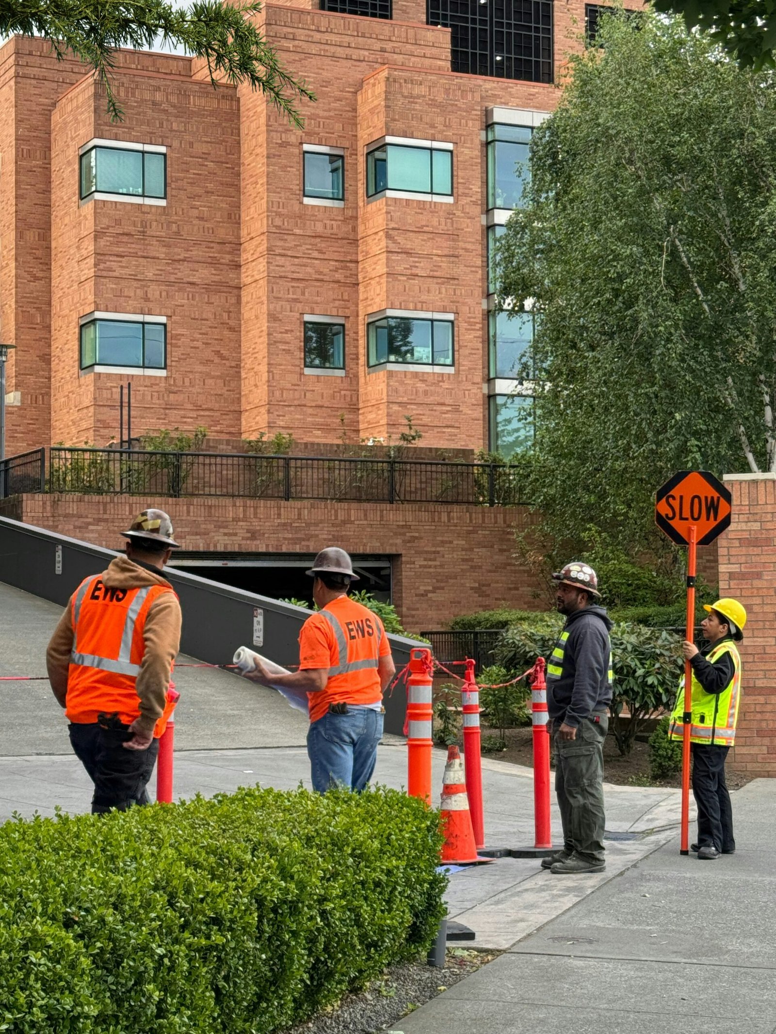 a group of men standing next to each other on a sidewalk